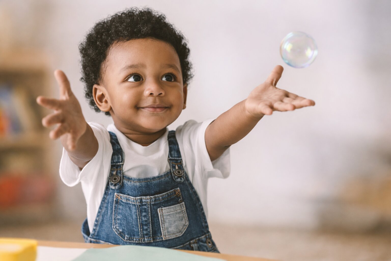 Happy young child playing with bubbles at Sky Early Learning